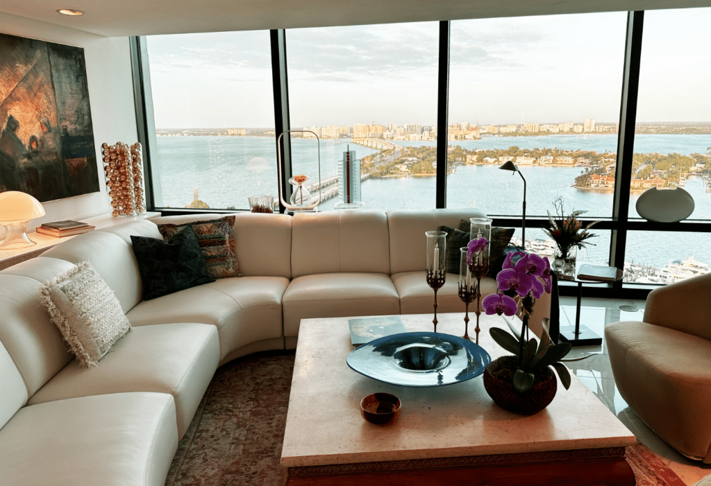 Living room in a senior residence with a view of the water in Plymouth Harbor on Sarasota Bay