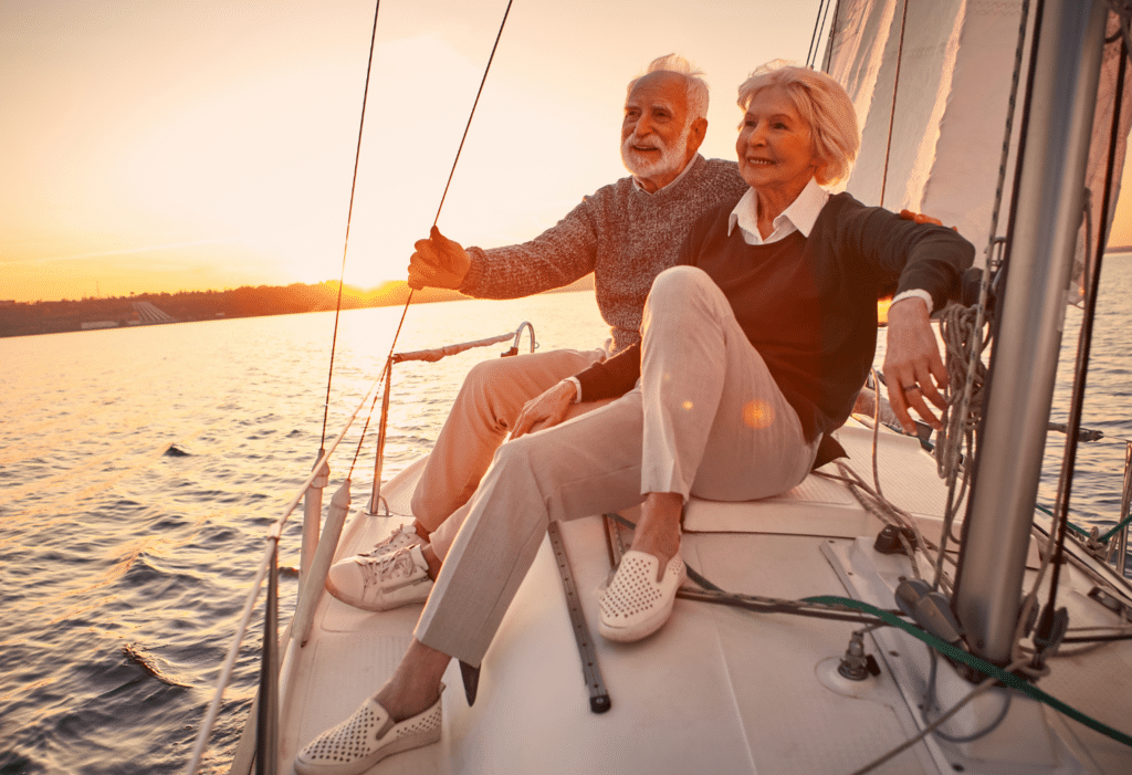 Senior couple sitting on a sailboat on the water