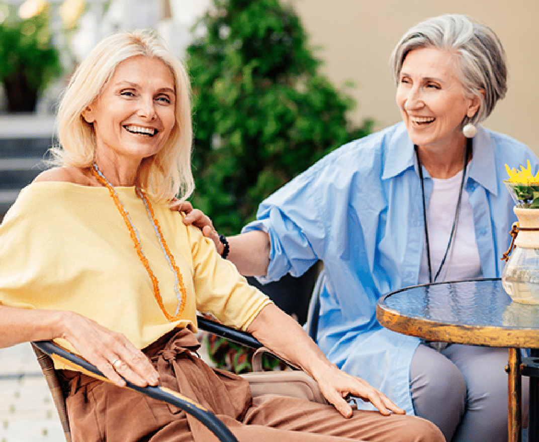Plymouth Harbor on Sarasota Bay: Senior Women Sitting at Table Outside Laughing