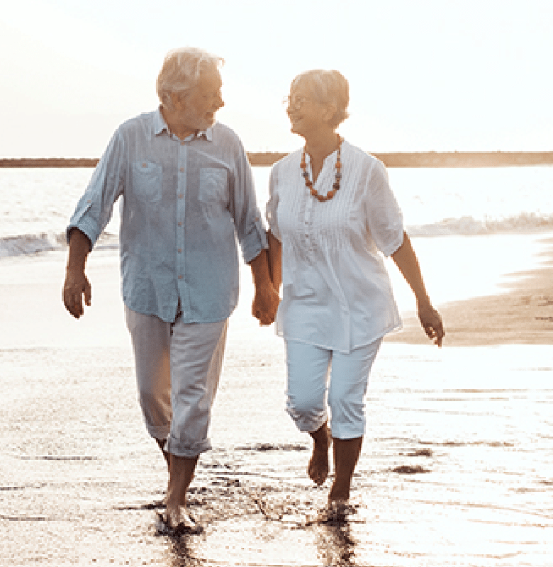 Plymouth Harbor on Sarasota Bay: Senior Couple Walking on Beach Holding Hands