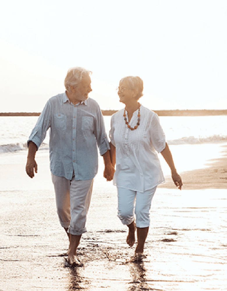 Plymouth Harbor on Sarasota Bay: Senior Couple Walking on Beach Holding Hands