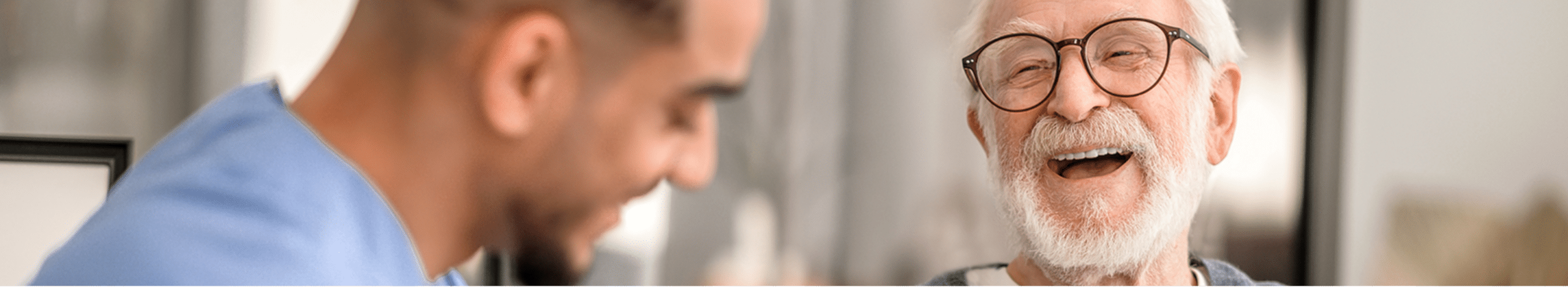 Plymouth Harbor on Sarasota Bay: Senior Man Laughing with Caregiver
