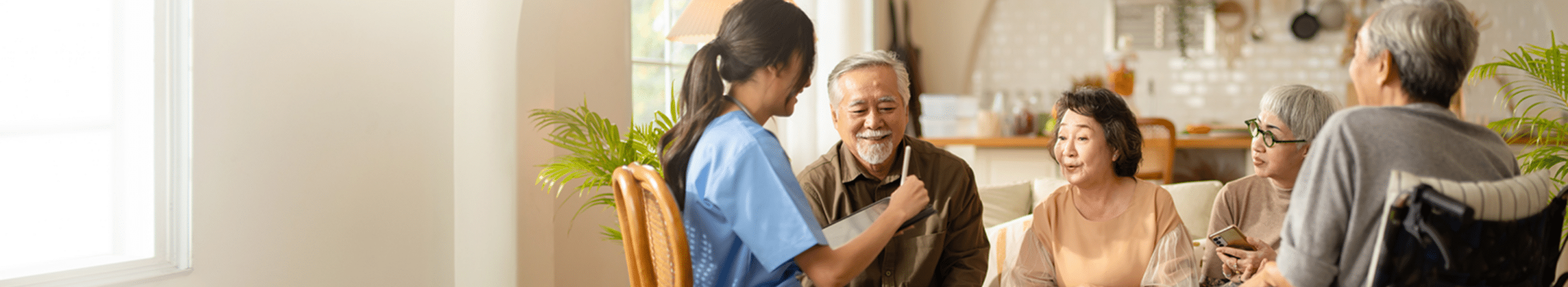 Seniors sitting on a sofa talking with a medical professional