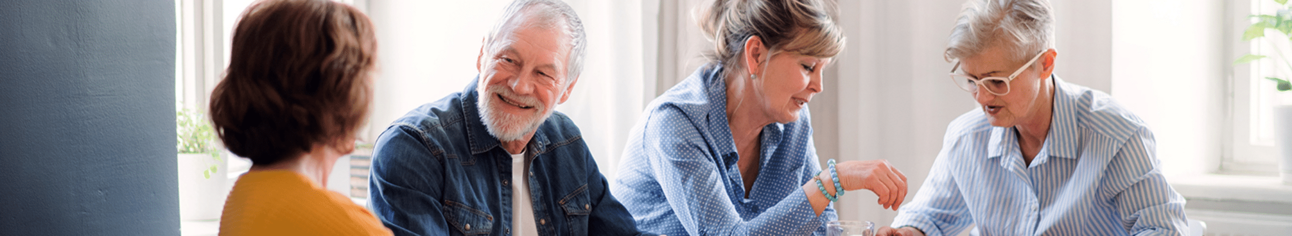 Plymouth Harbor on Sarasota Bay: Senior Man and Women Sitting at a Table
