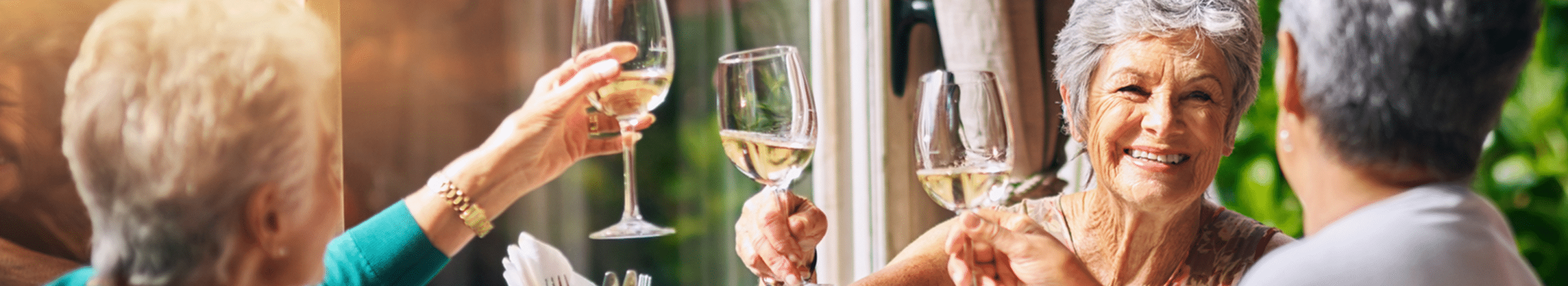 Senior women holding wine glasses