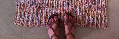 Feet in sandals standing on an area rug