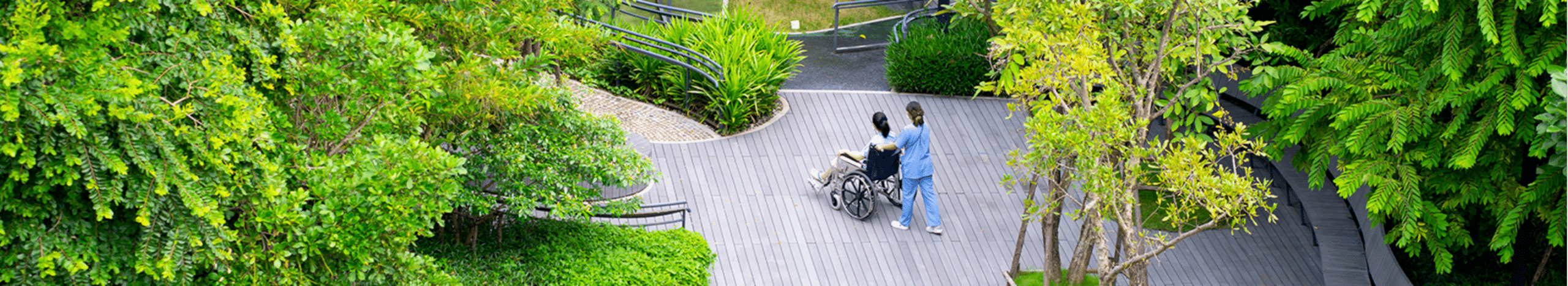 Plymouth Harbor on Sarasota Bay: Caregiver Pushing Senior in Wheelchair on Outside Deck