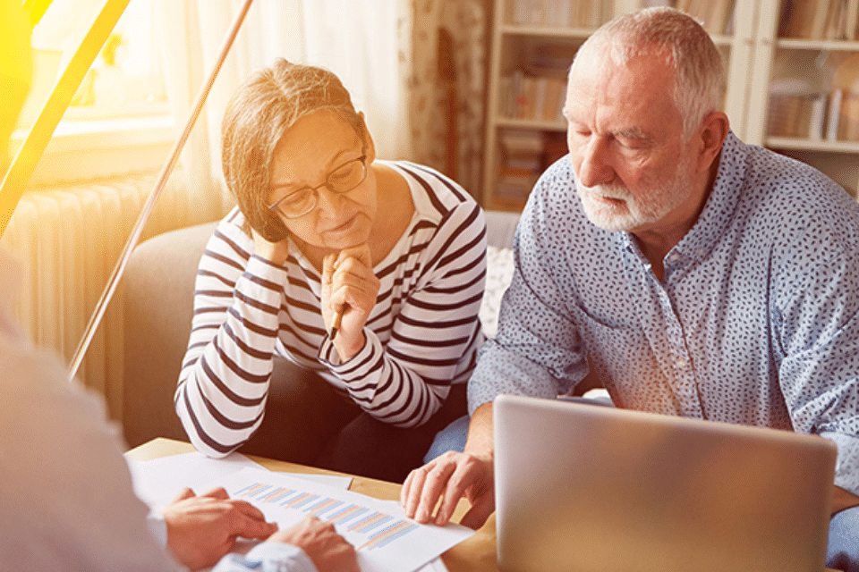 Plymouth Harbor on Sarasota Bay: Senior Man and Woman Looking at Computer and Financial Papers