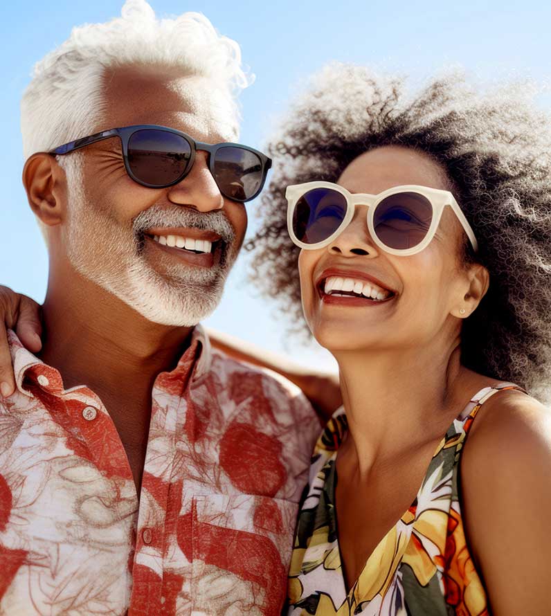 An older couple embracing and smiling in the sunshine