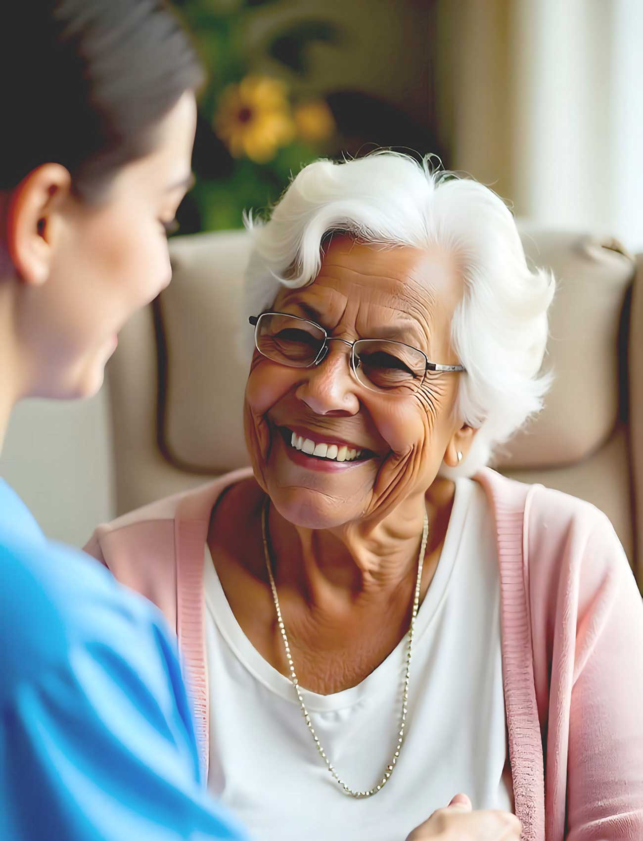 A smiling woman engages in conversation with an older woman