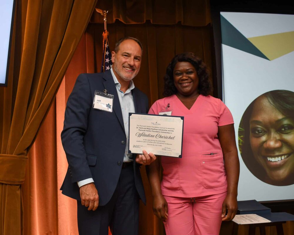 Jeff Weatherhead standing with Wiladine Cherichel, a scholarship recipient